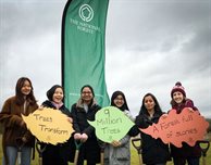 Students plant the first of 1,000 DMU trees in the National Forest