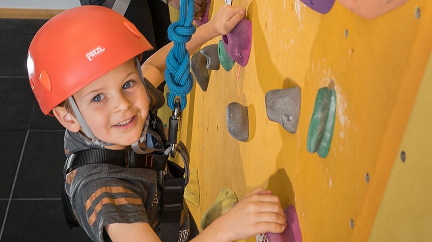 Children at a climbing wall party at the DMU leisure centre