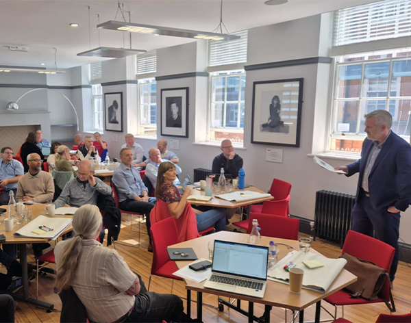 Police practitioners and university researchers discussing evidence together at a workshop