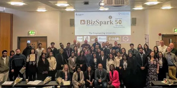 A large group of students in a classroom in front of a presentation slide that says "BizSpark"