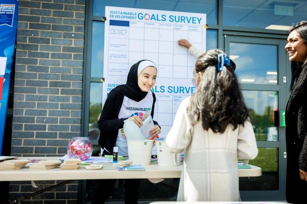 A youngster taking part in the SDG survey at Leicester Nirvana with DMU volunteers