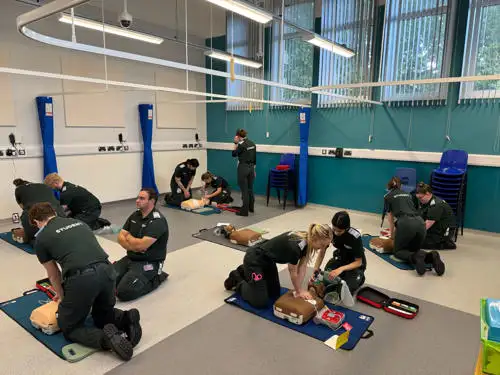 Group of students practising basic life support (CPR)