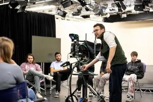 Students learning about the operation of a TV studio camera