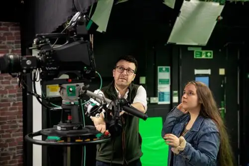 Student being instructed on the use of a TV studio camera