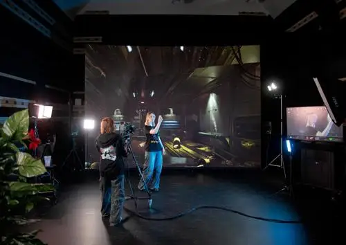 Two students using the LED wall and 3D generated imagery to compose a scene.