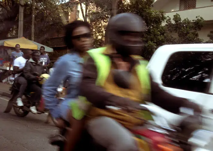 Adaeze Akande: Motion blurred photo of people on scooters driving down a city street