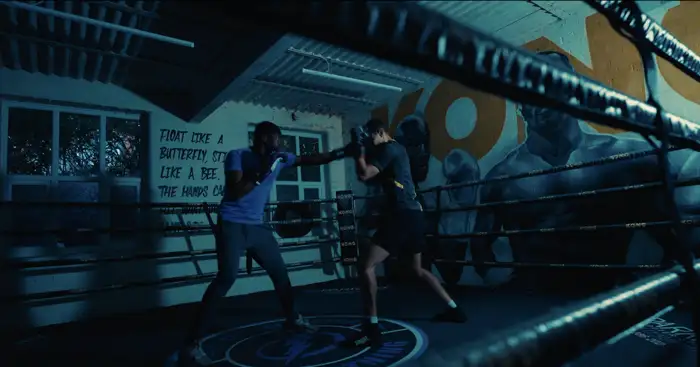 Ben Waterfield: Two men boxing in a darkened, blue-lit ring