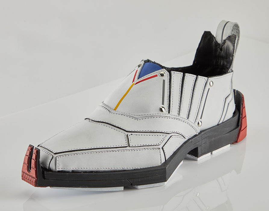 A white, masculine dress shoe with red, yellow, and blue highlights in a Gundam style