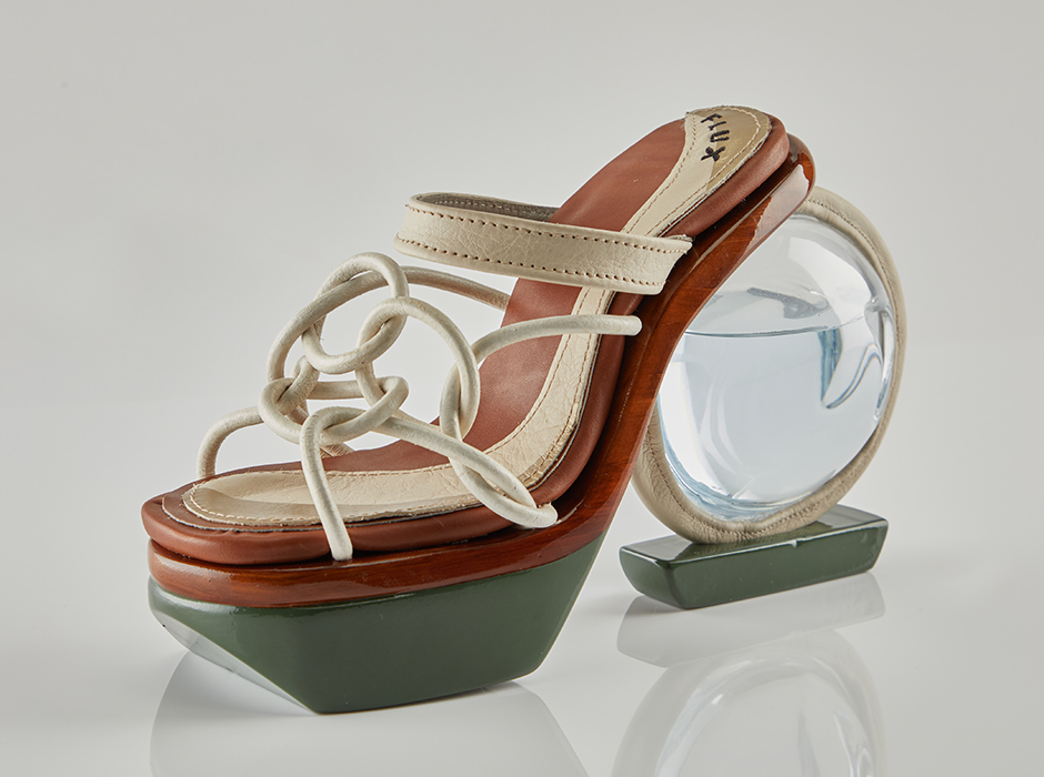 A high-heeled shoe, where the heel is made from a transparent globe filled with water