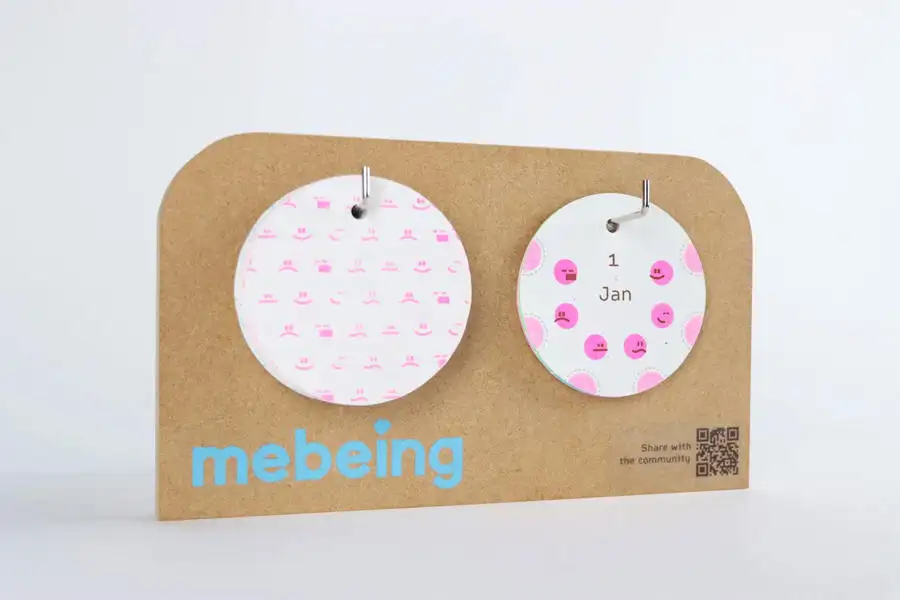 Two circular baby milestone cards with pink patterns on a brown card backing labelled "milestone."