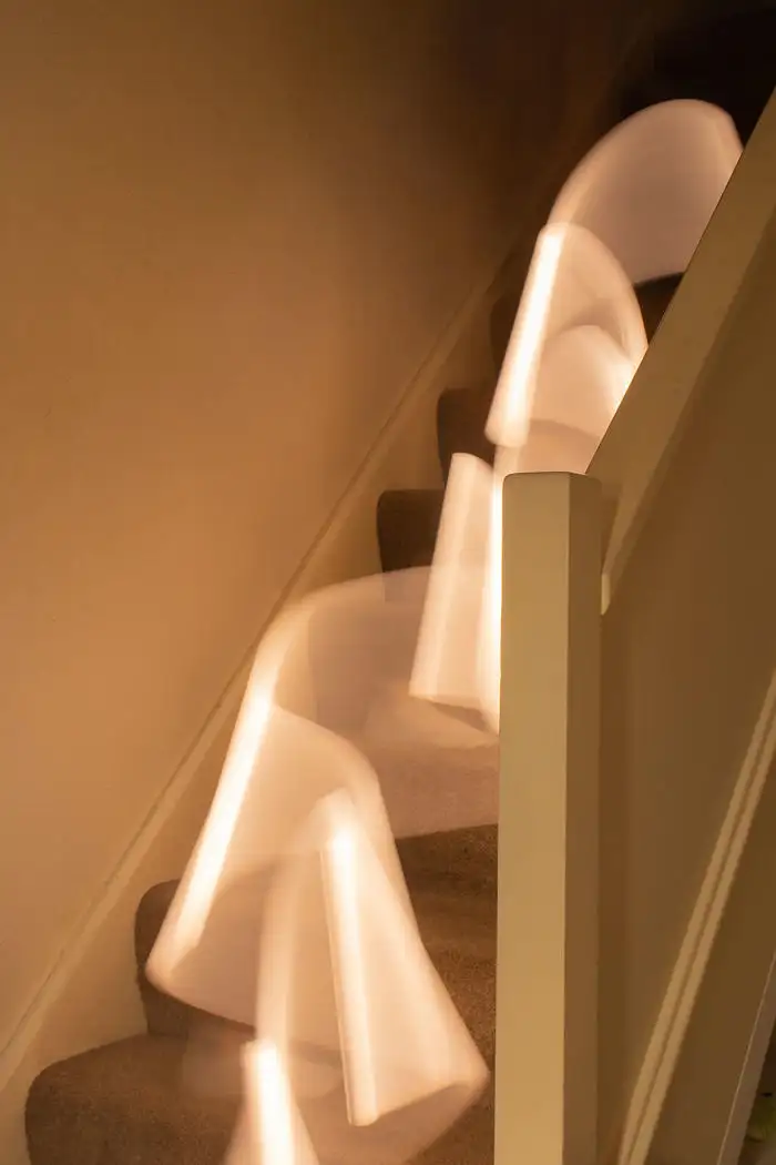Long exposure of a light source moving down a household staircase - by Stephanie Case