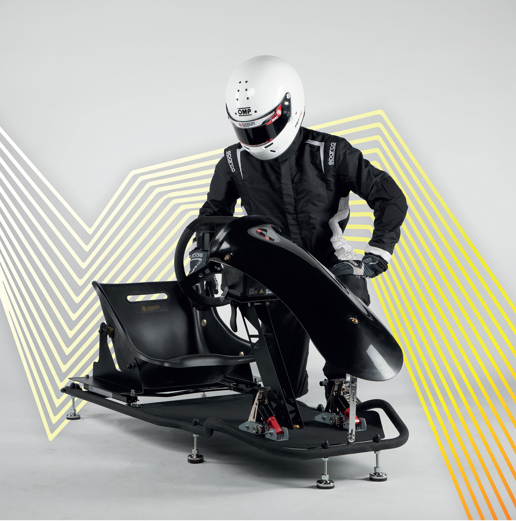 A student in a white helmet standing next to Velocity Kart Simulator