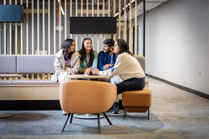 DMU London students learning and collaborating in a modern university environment