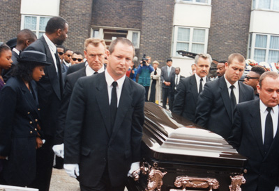 Stephens coffin being carried as mourners watch, at Stephen's funeral