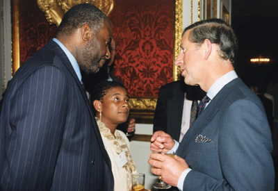Doreen and Neville Lawrence speaking to HRH The Prince of Wales at an event.