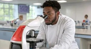 Scientist looking through a microscope