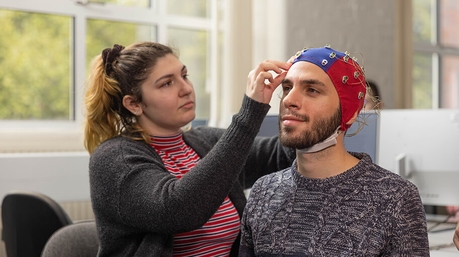 An EEG is composed of a number of small sensors that are used to record electrical signals in the brain. This equipment is located in our EEG lab, and can be used as part of cognitive research to capture how the brain responds to specific stimuli.