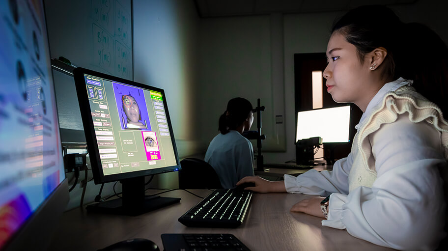 In this image, the participant (far right of the screen) is connected to an eye tracker as part of an experiment, while the researcher is accessing the responses. Eye trackers are used to capture eye movements, and have many applications in psychology (e.g. visual attention, behaviour and cognition). Students can access these in our Eye Tracker Suite.